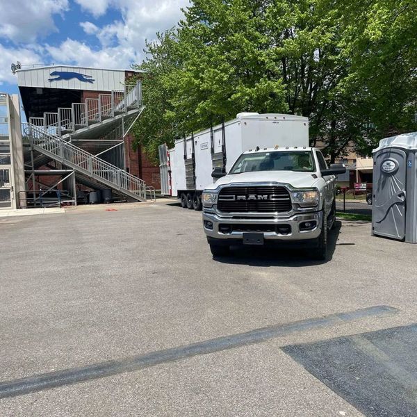 9 stall restroom outside of building next to truck