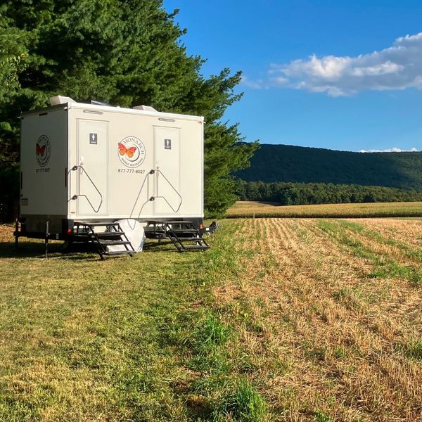 2 stall unit outside on field with mountains in the background