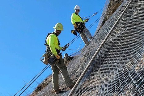 men repelling on mountain