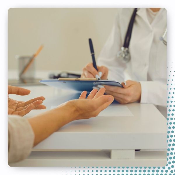 doctor writing on clipboard