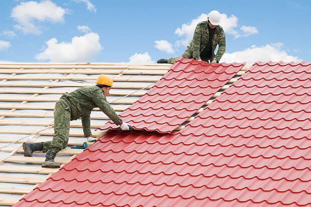 roofing contractors working on roof