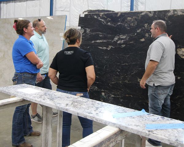 customers looking at slabs inside of the Canaan Stone Works building