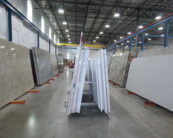 rows of different stone slabs inside of the Canaan Stone Works building