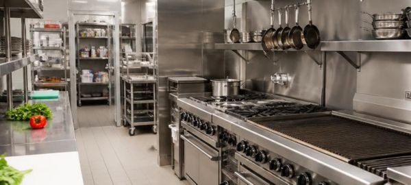 Clean stainless steel commercial restaurant kitchen prep area and cookline