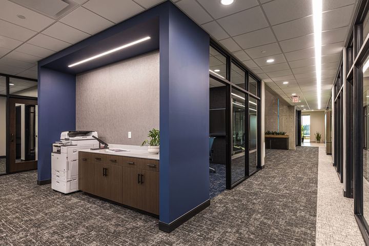 Corporate office interior construction at Hoeft Builders in Eau Claire, WI featuring a work station and small conference room with aluminum storefront glass Corporate office interior construction at Hoeft Builders in Eau Claire, WI