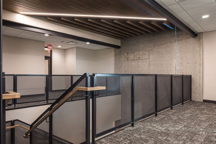 Office interior construction at Hoeft Builders in Eau Claire, WI featuring steel stair railings, interior precast wall, and acoustical baffles. Office interior construction at Hoeft Builders in Eau Claire, WI