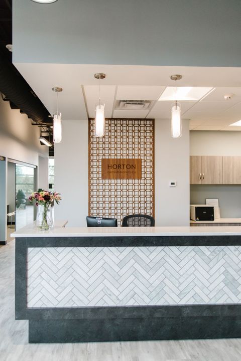 Interior construction of Horton Orthodontics in Woodbury, Minnesota, featuring reception desk, built by Hoeft Builders Reception desk at Horton Orthodontics in Woodbury, MN - Hoeft Builders