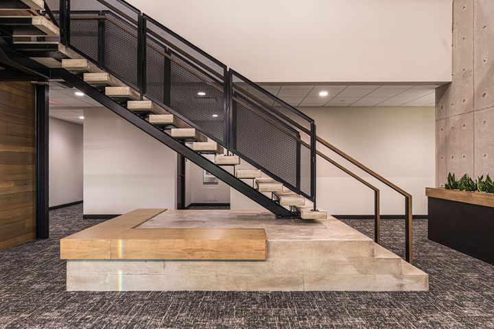 Corporate office interior construction at Hoeft Builders in Eau Claire, WI featuring custom poured-in-place concrete focal staircase Corporate office interior construction at Hoeft Builders in Eau Claire, WI