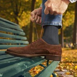 Men lifestyle with dress shoe on park bench.jpg