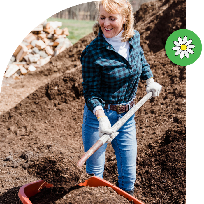 woman shoveling compost