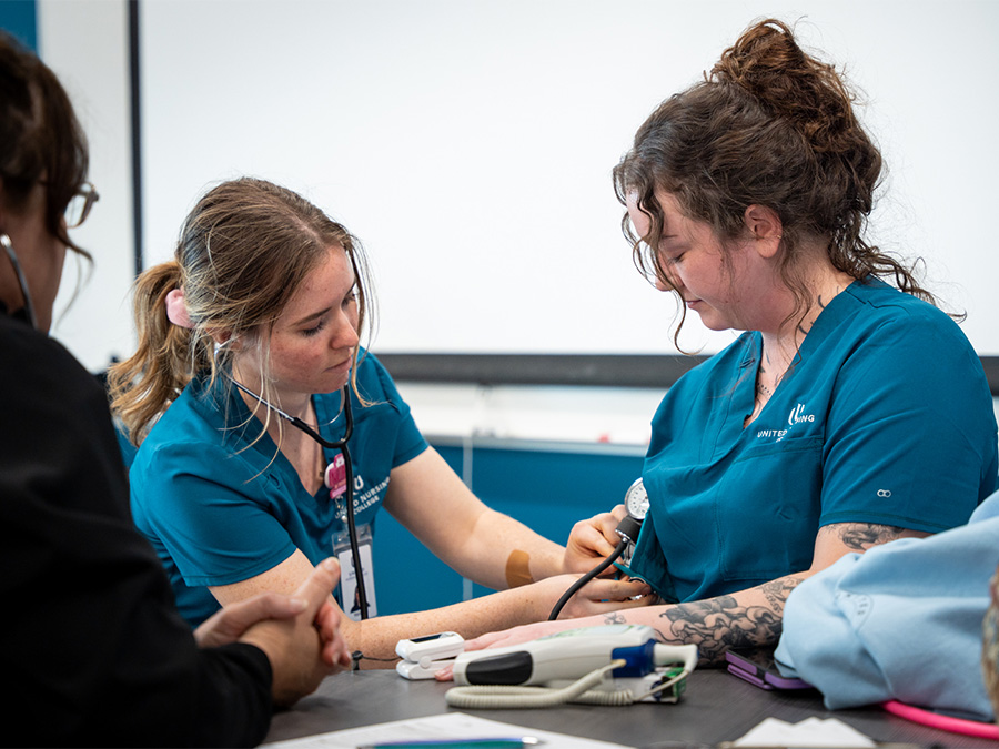 Two ADN students in a United Nursing College classroom