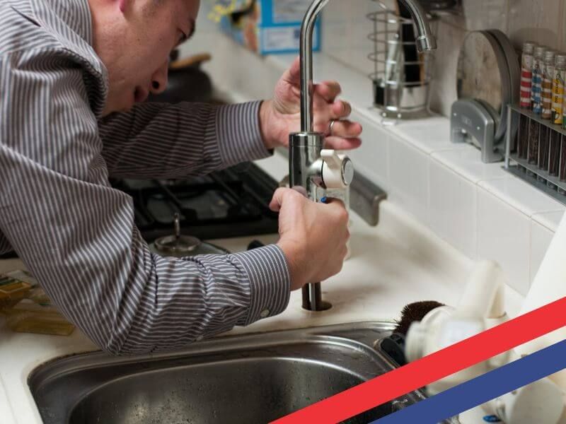 man installing faucet plumbing supplies